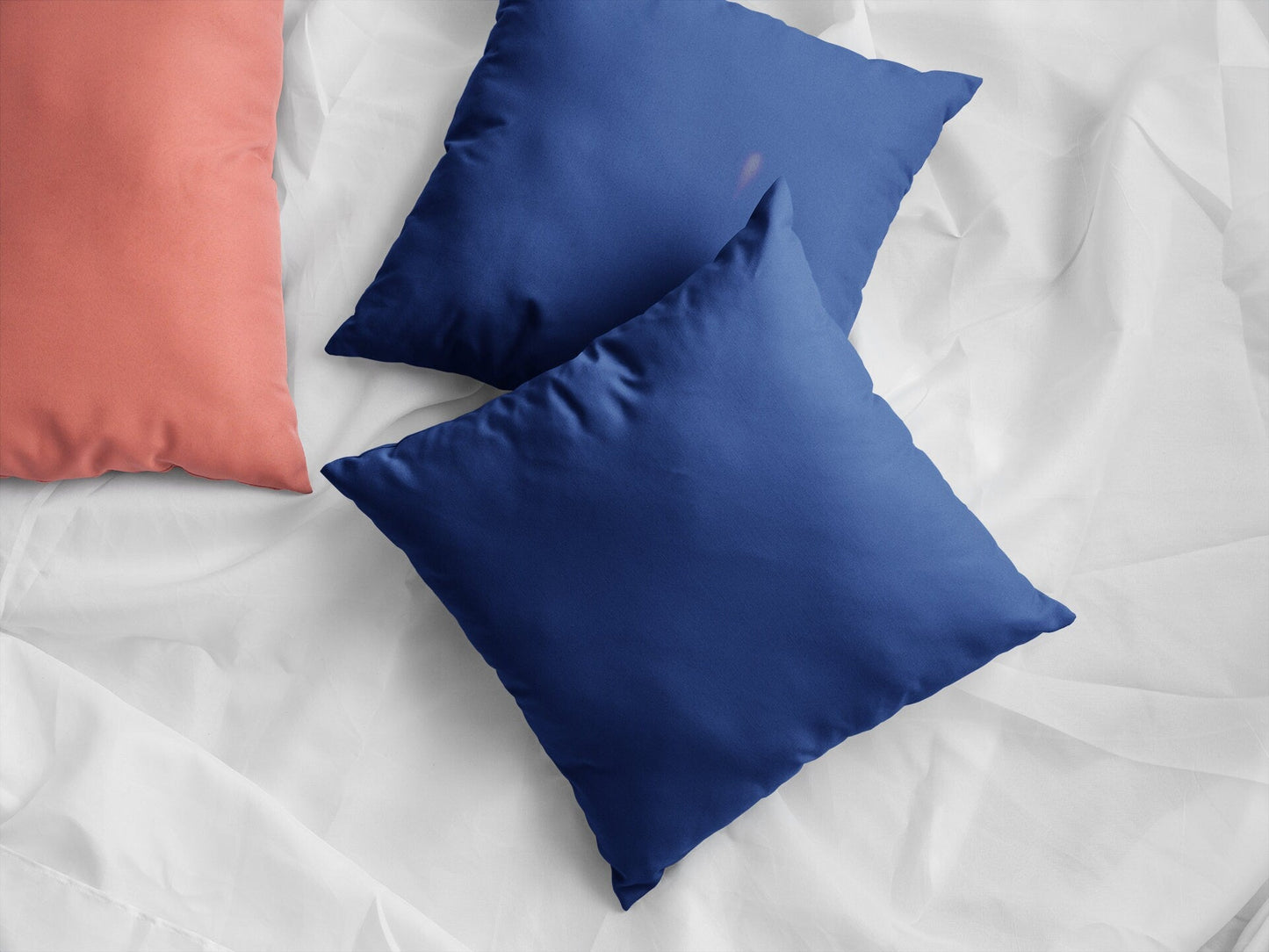 Blue Pillows on White Sheet