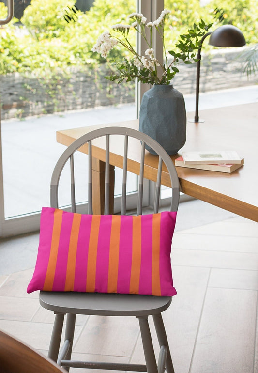 orange and pink lumbar pillow on chair