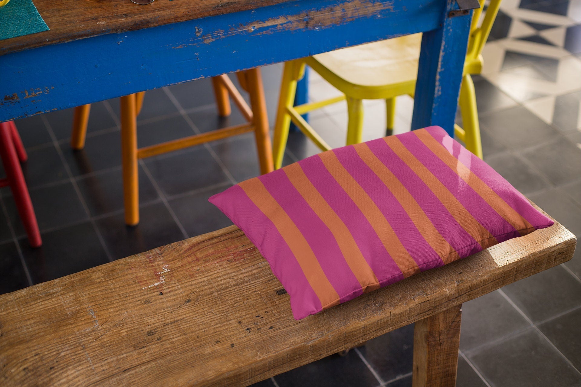orange and pink outdoor pillow on bench