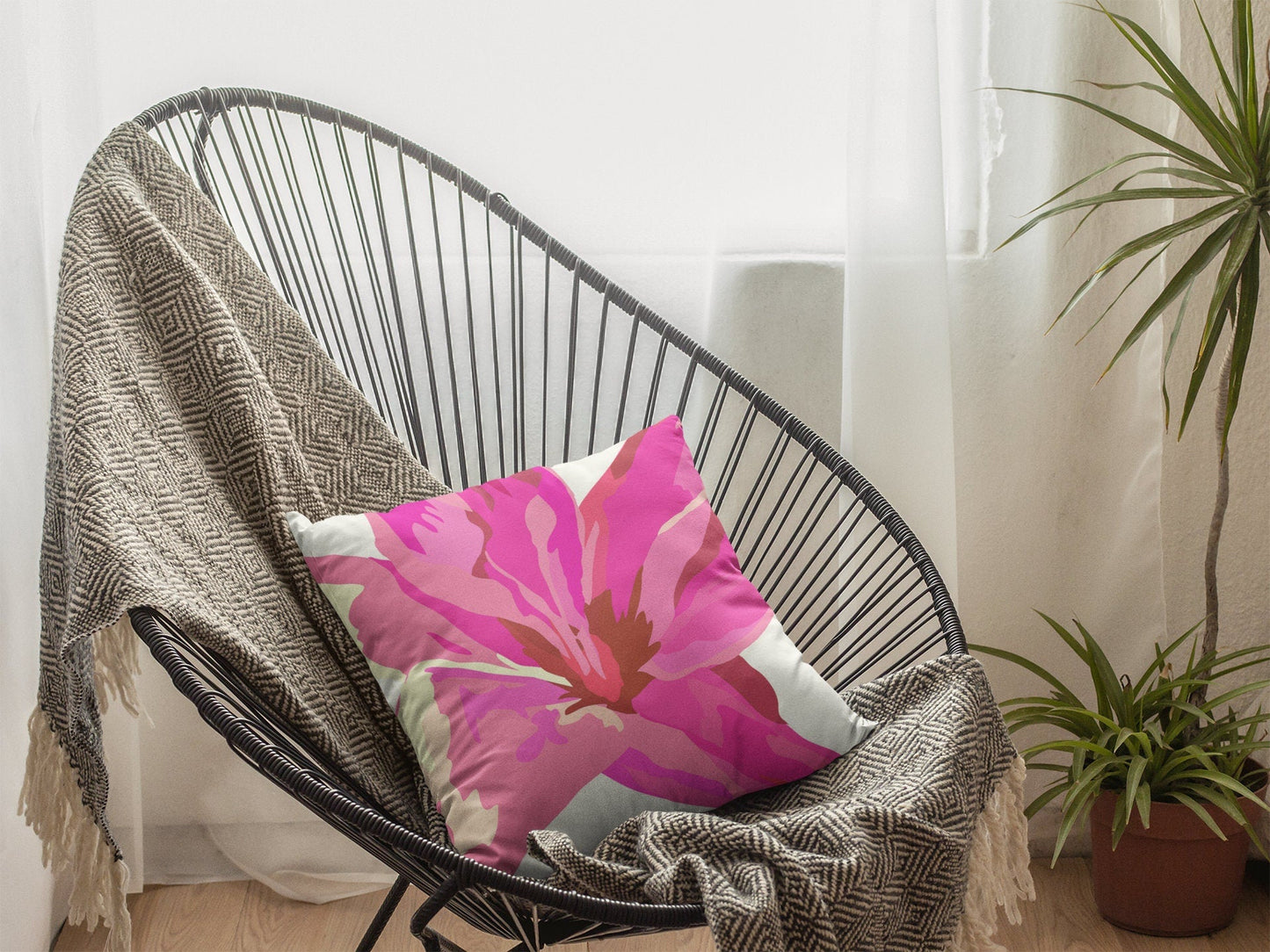 pink flower pillow in wicker chair